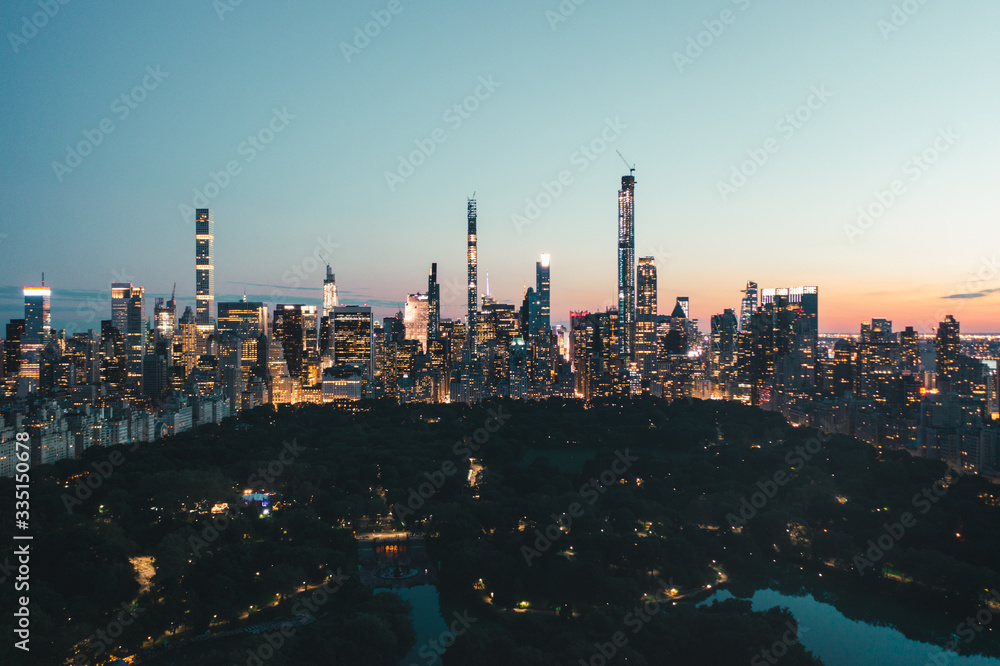 Spectacular Wide View over Central Park in Manhattan at Night with Flashing Cityscape Skyline of New York City 