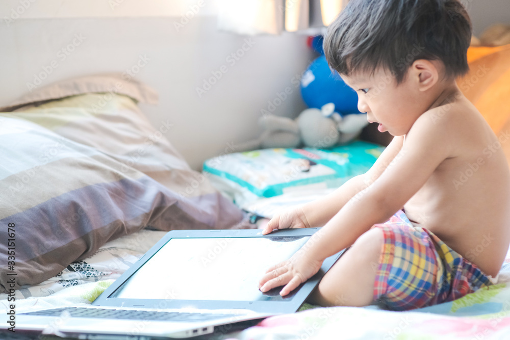 Funny baby boy playing with laptop computer work from home in cozy room Funny baby boy playing with laptop computer work from home in cozy room