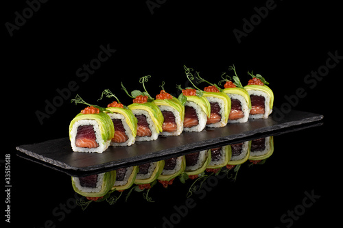 Rolls sushi black background reflection basalt asian food japan food © Dmitry