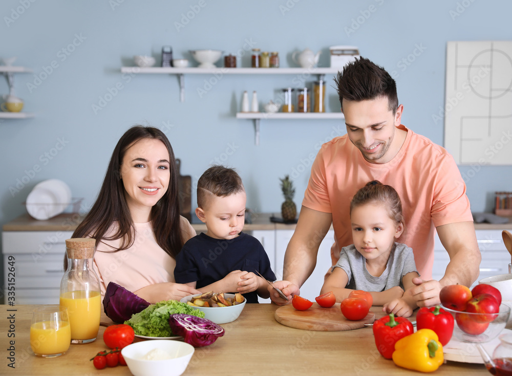 Young family cooking together in kitchen Young family cooking together in kitchen