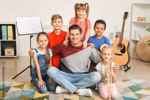 Music teacher with little c...