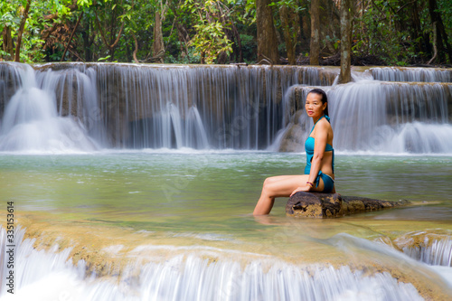Woman in blue swimsuit at Huai Mae Khamin waterfall