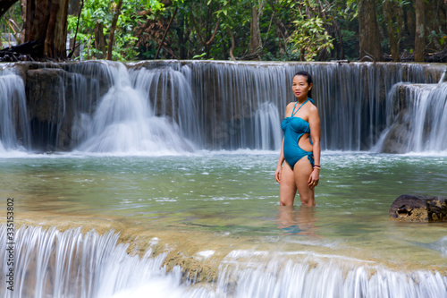 Fototapeta Naklejka Na Ścianę i Meble -  Woman with blue swimsuit at Huai Mae Khamin waterfall