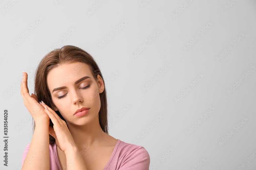 Young woman with beautiful makeup on light background Young woman with beautiful makeup on light background