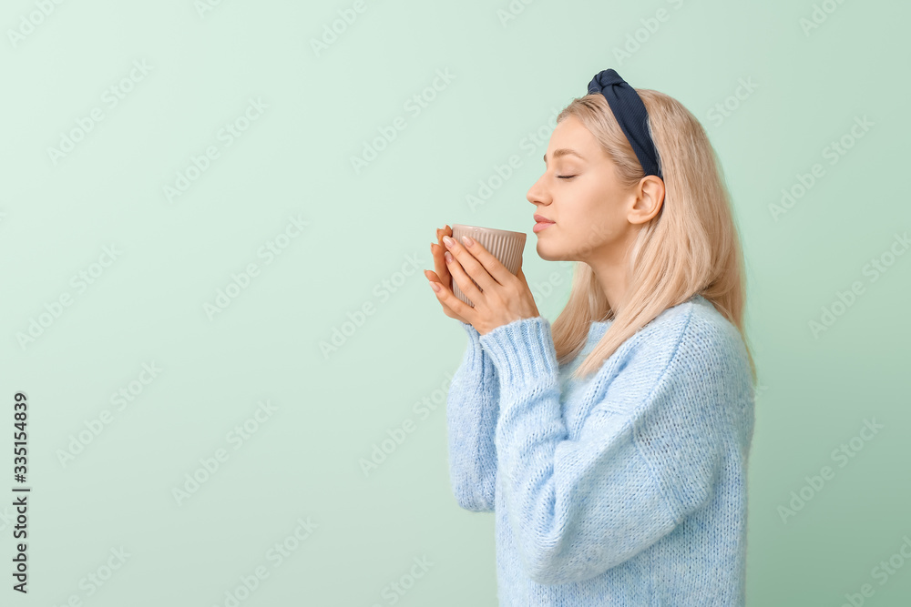 Beautiful young woman with tea on color background Beautiful young woman with tea on color background