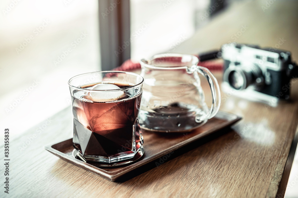 Cold brew coffee, ice black coffee drip on the table cafe background