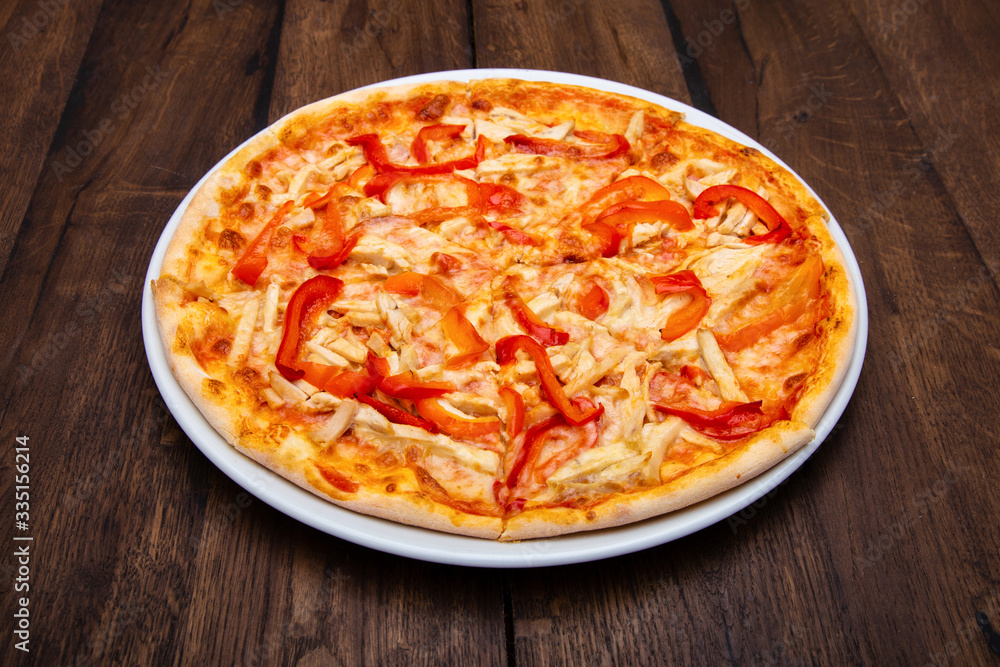 Classic Italian pizza on a wooden table Classic Italian pizza on a wooden table