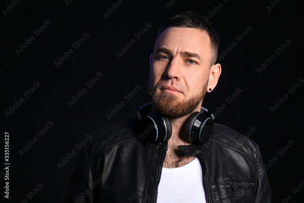 Handsome man with headphones on dark background Handsome man with headphones on dark background