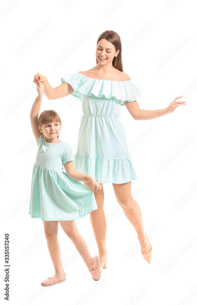 Happy mother and her little daughter dancing against white background Happy mother and her little daughter dancing against white background