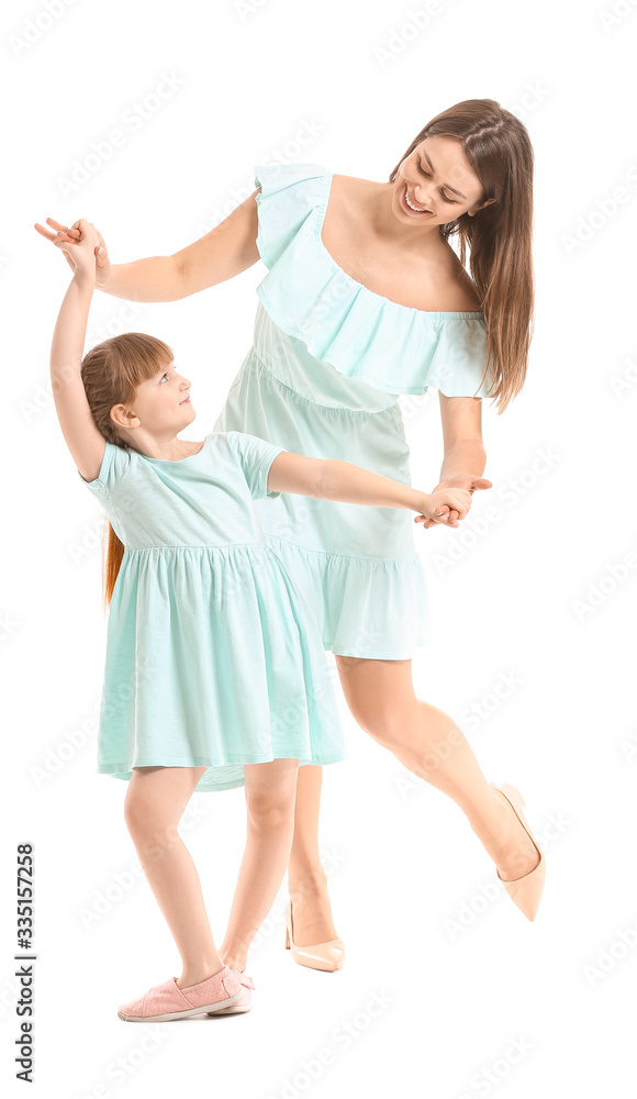 Happy mother and her little daughter dancing against white background Happy mother and her little daughter dancing against white background