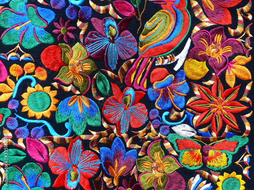 Close up of сolorful embroidered decorative textile and pillows at the artisan's market in Otavalo, Ecuador	
