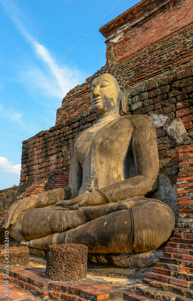 Old big Buddha statue in archaeological site Sukhothai, Thailand Old big Buddha statue in archaeological site Sukhothai, Thailand