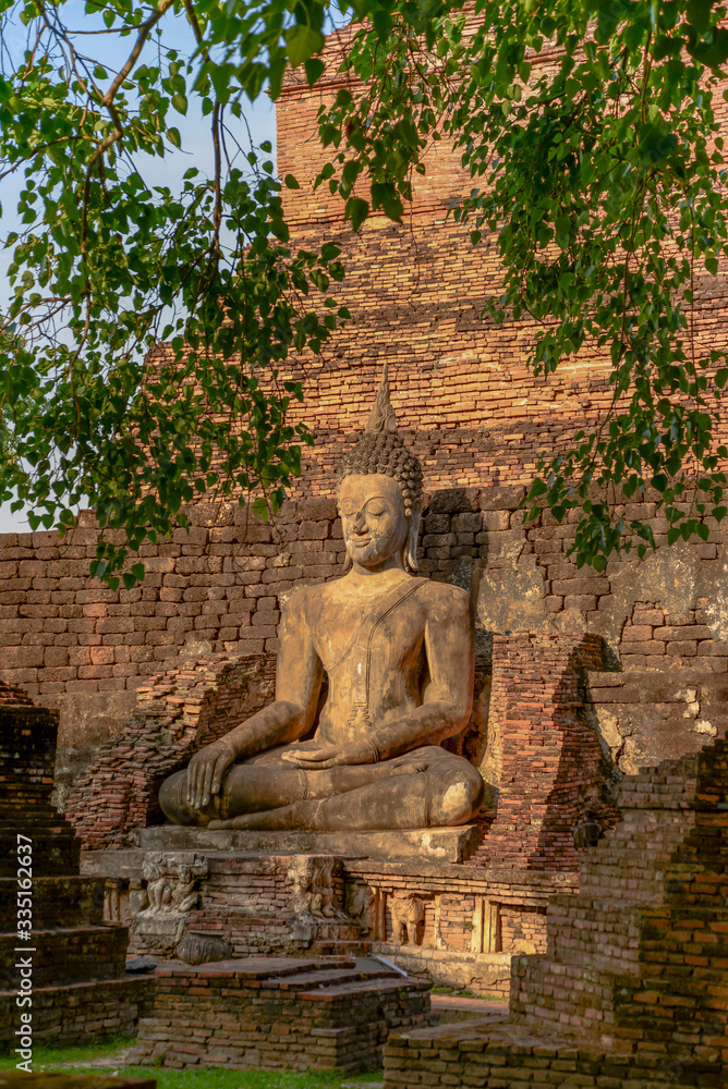 Old big Buddha statue in archaeological site Sukhothai, Thailand