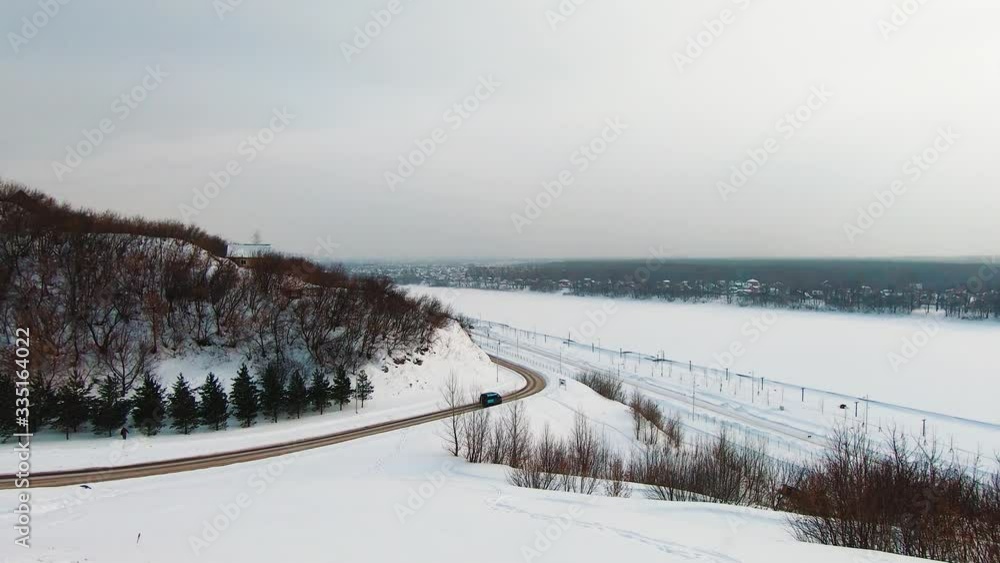 Scenic snowy mountain in Ufa, Russia beside frozen Belaya River Scenic snowy mountain in Ufa, Russia beside frozen Belaya River