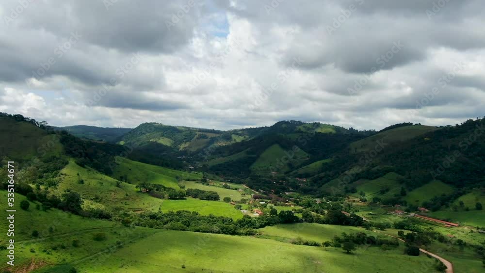 Aerial view of green tropical mountain and small valley in Monte Alegre do Sul in the state of Sao Paulo in Brazil. Aerial view of green tropical mountain and small valley in Monte Alegre do Sul in the state of Sao Paulo in Brazil.