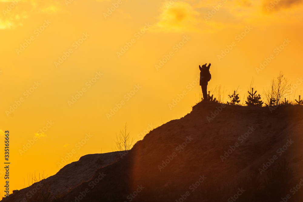 man at the top of the mountain at sunset success