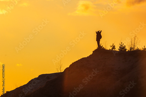 man at the top of the mountain at sunset success