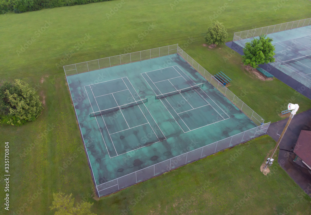 Set of tennis courts aerial view after summer rainfall