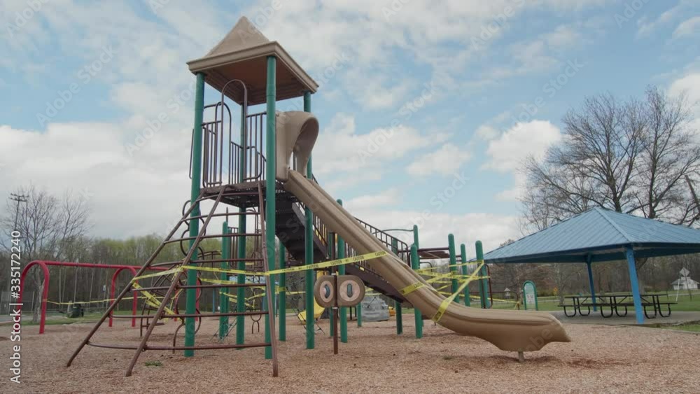 Time-lapse of a playground with caution tape due to social distancing and the COVID-19 coronavirus outbreak. 4K, UHD, V-Log corrected. Shot on a Panasonic GH5. Time-lapse of a playground with caution tape due to social distancing and the COVID-19 coronavirus outbreak. 4K, UHD, V-Log corrected. Shot on a Panasonic GH5.
