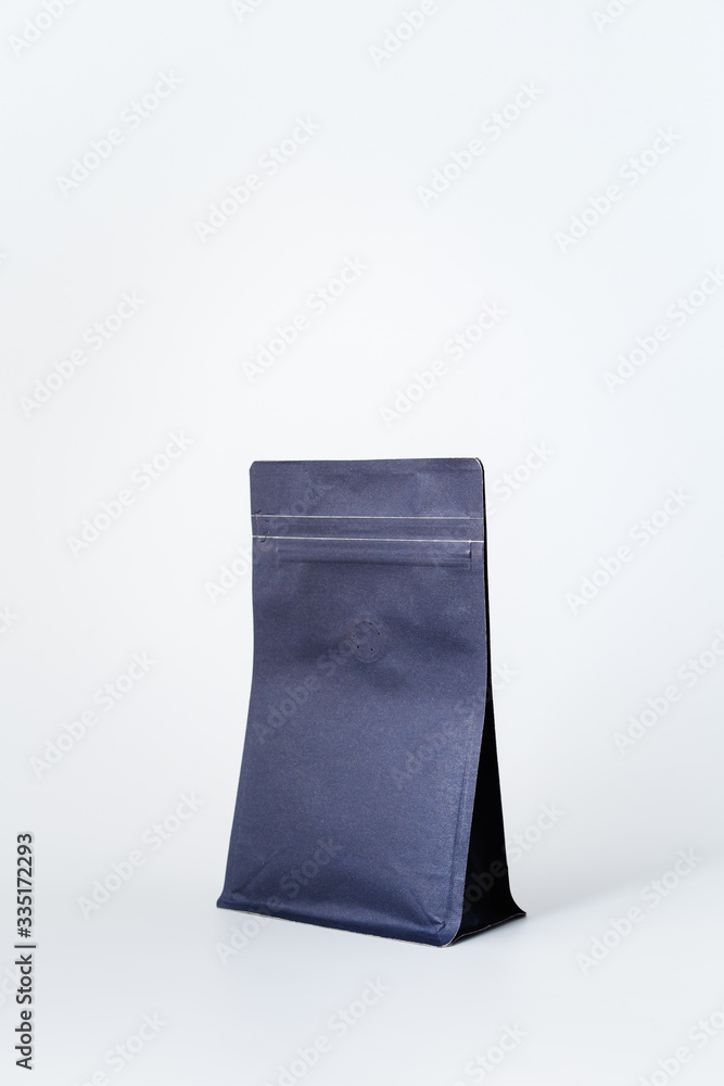dark blue paper ziplock package with valve for roasted coffee bean on white background