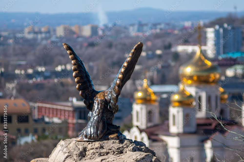 Fototapeta premium Eagle sculpture and church view