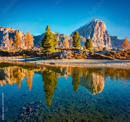Amazing autumn scene of Limides Lake and Lagazuoi mountain. Sunny morning view of Dolomite Alps, Falzarego pass, Cortina d'Ampezzo lacattion, Italy, Europe. Beauty of nature concept background.