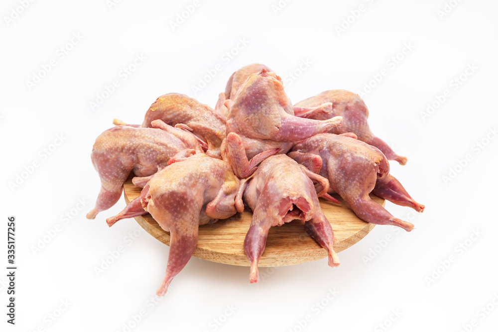 Fresh quail carcasses before cooking on a white background Fresh quail carcasses before cooking on a white background