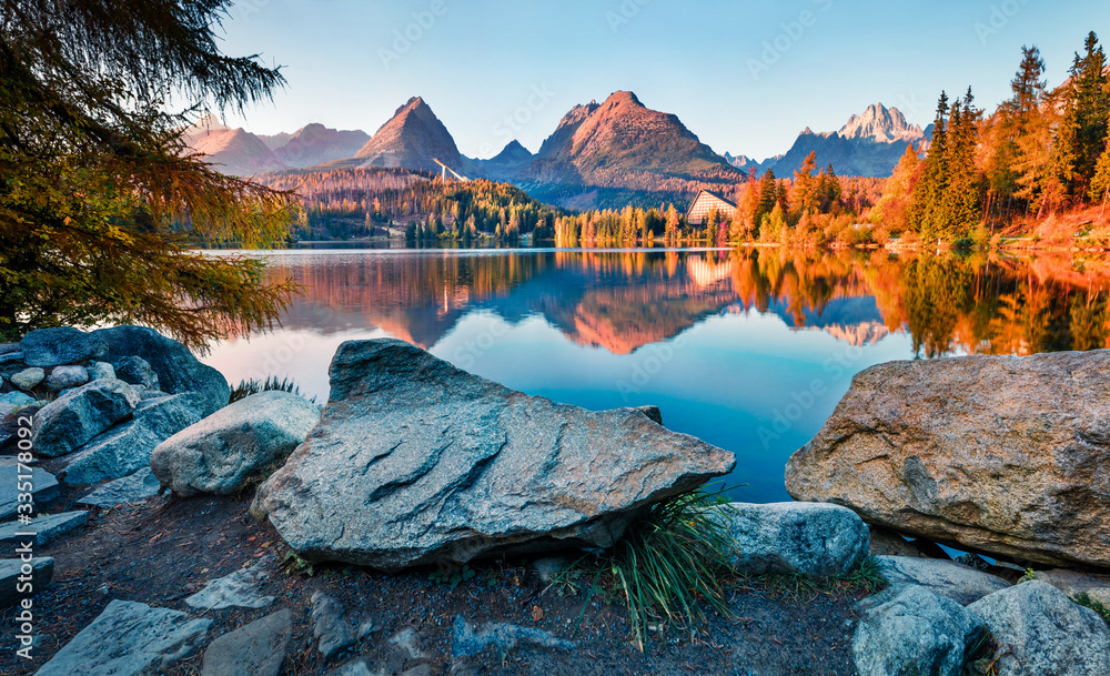 Fototapeta Last sunlight glowing of mountain hills on Strbske pleso lake. Exciting evening scene of High Tatras National Park, Slovakia, Europe. Beauty of nature concept background.
