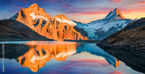 Awesome evening panorama of Bachalp lake (Bachalpsee), Switzerland. Unbelievable autumn sunset in Swiss Alps, Grindelwald, Bernese Oberland, Europe. Beauty of nature concept background. photo