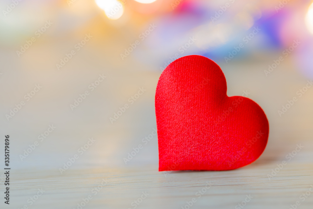 Red heart shape on wood table with soft bokeh Red heart shape on wood table with soft bokeh