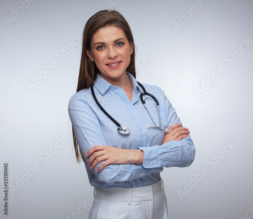 Portrait of smiling female medical worker with folded hands.