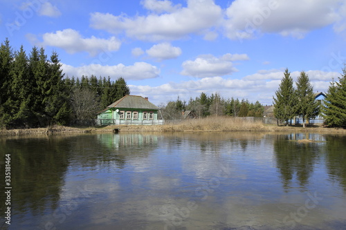 Old russian house on the pond