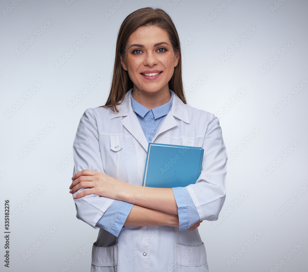 smiling woman doctor in white uniform holding books. smiling woman doctor in white uniform holding books.