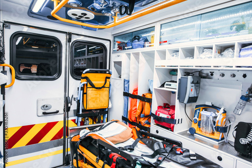 Ambulance interior with emergency equipment, stretcher and transfer chair. Emergency concept.