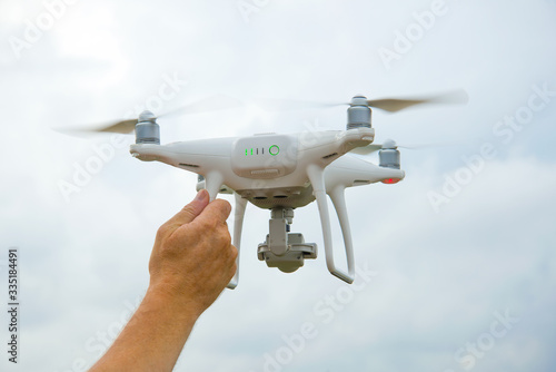 Male hand holds a working quadrocopter