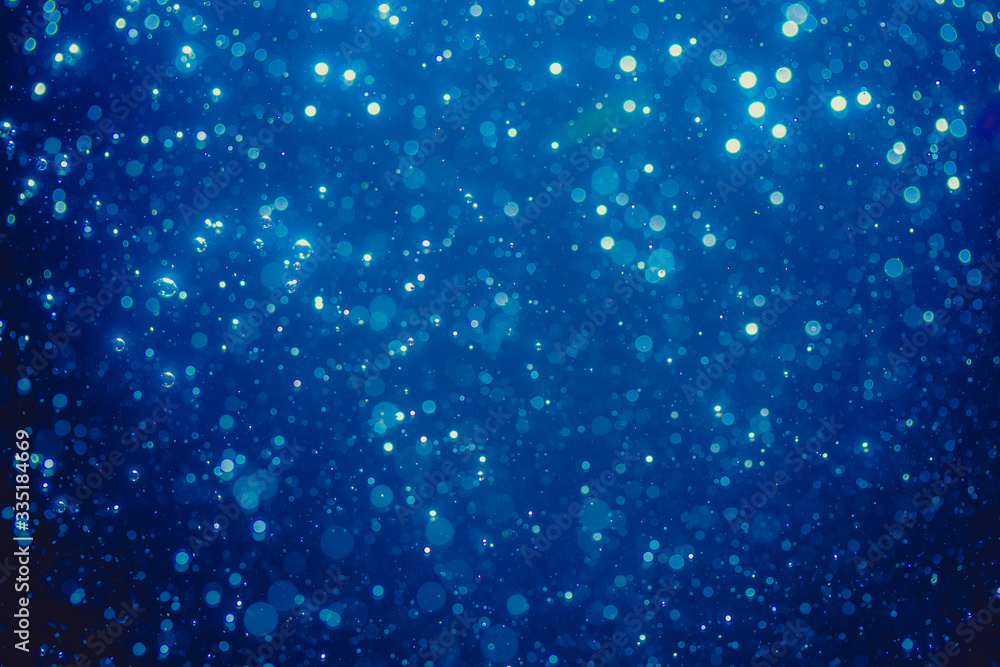 Abstract blue defocused bokeh of lights in dark