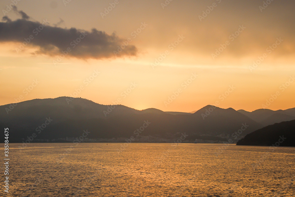 Corfu island beaches, waterfront, sea, bay, view from a ferry, beautiful sunset, Greece