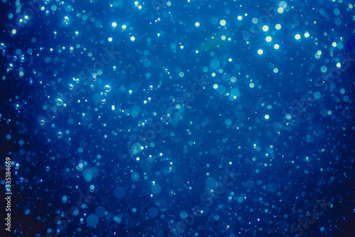 Abstract blue defocused bokeh of lights in dark
