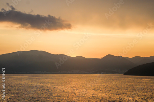 Corfu island beaches, waterfront, sea, bay, view from a ferry, beautiful sunset, Greece