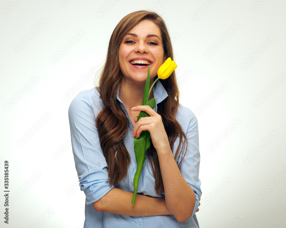 Smiling girl holding one yellow tulip flower. Smiling girl holding one yellow tulip flower.