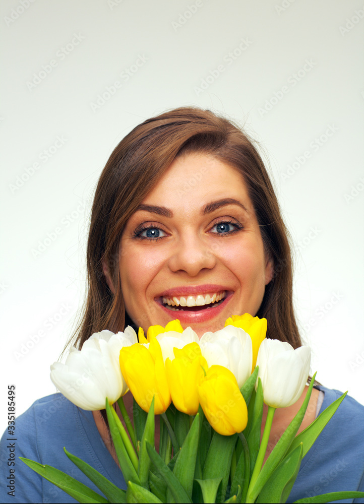 portrait of smiling woman holding tulips flowers in front of face portrait of smiling woman holding tulips flowers in front of face