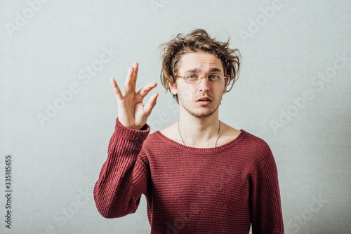 Принти на полотні The man in glasses showing a little bit, a little