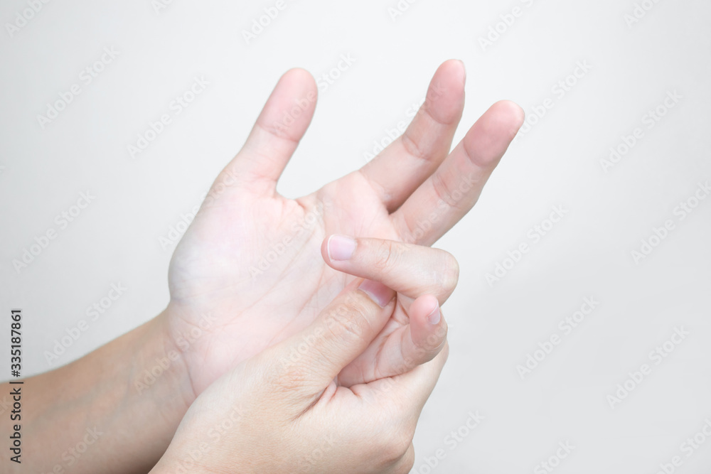 Young hands have pain in their hands and massage in painful fingers. Health care concept Young hands have pain in their hands and massage in painful fingers. Health care concept