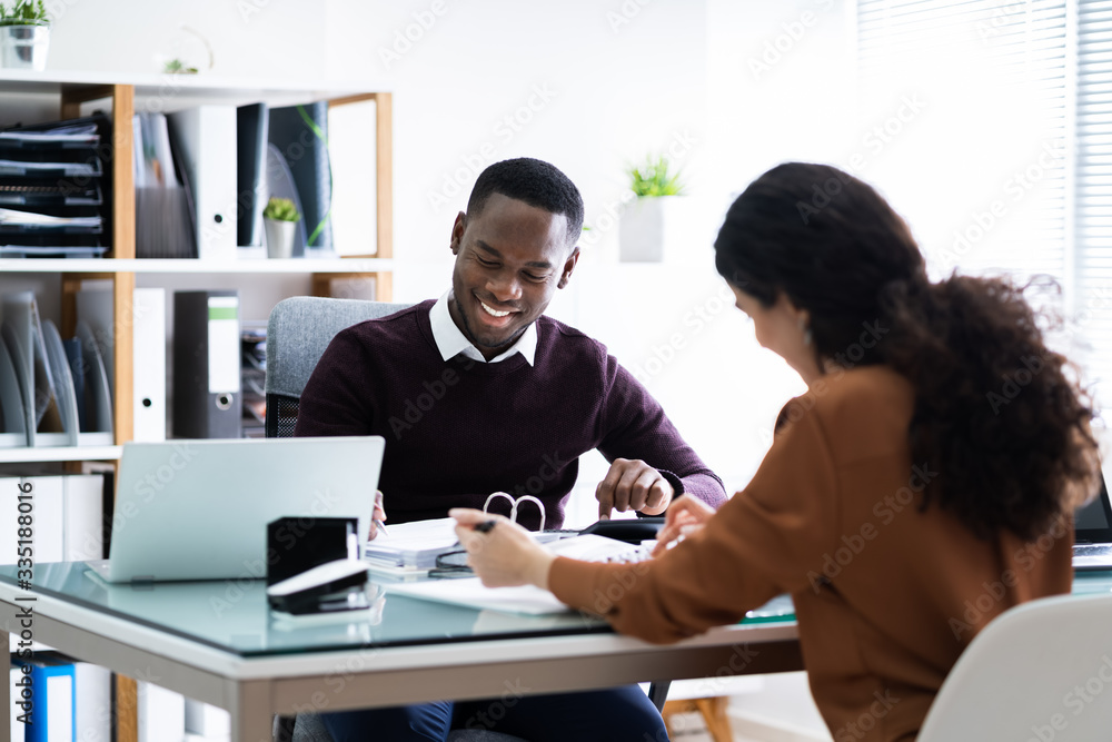 Two Businessman Using Calculator At Workplace Two Businessman Using Calculator At Workplace