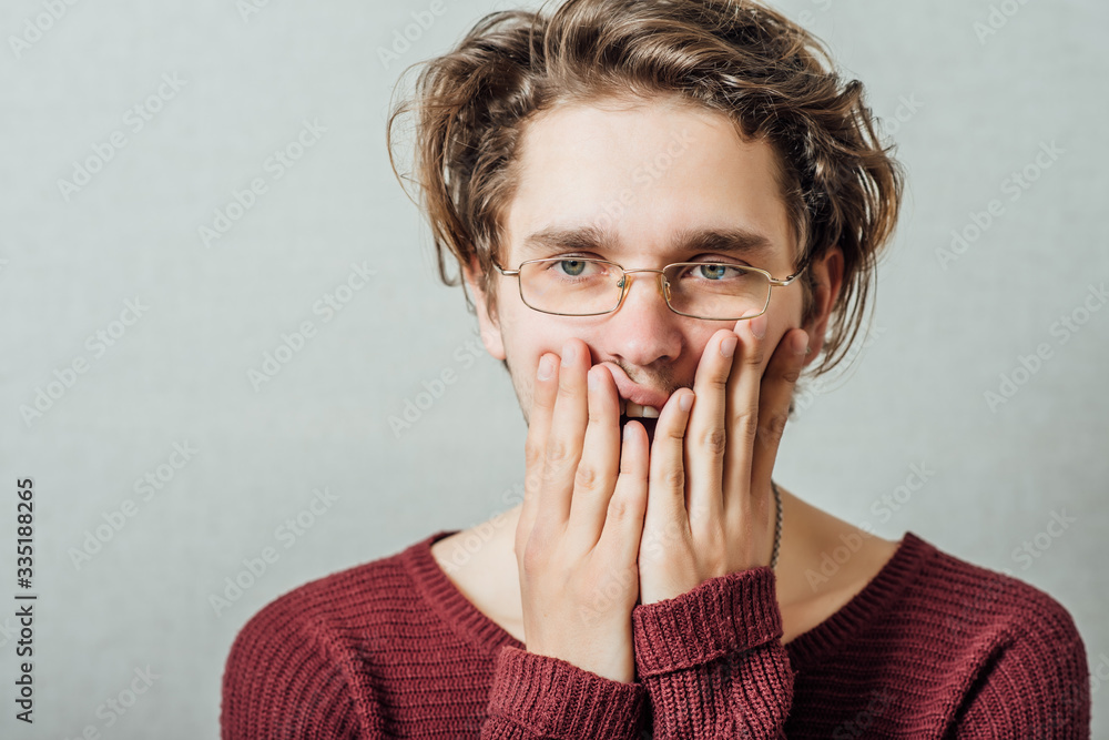 Young businessman holding head in his hands Young businessman holding head in his hands