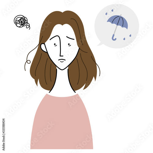 湿気で髪が乱れ、困った表情の女性