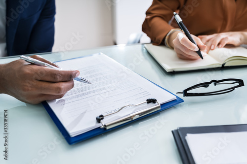 Two Businesspeople Analyzing Document