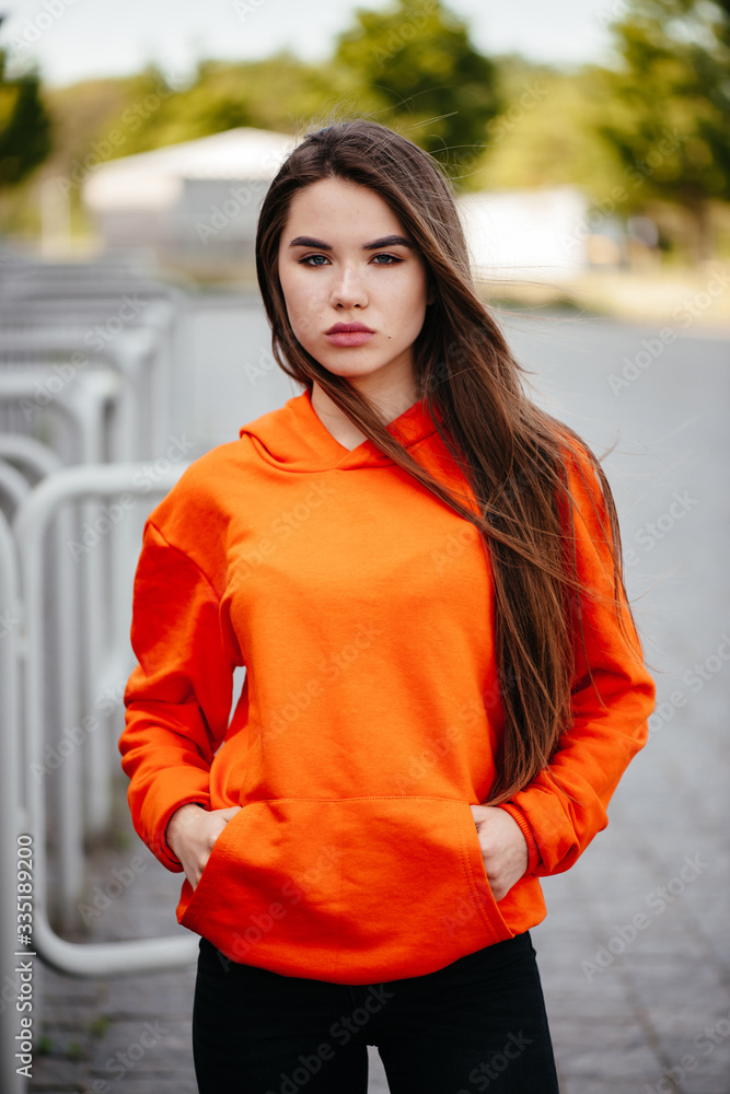 Close up photo of charming gorgeous woman being photographed wearing yellow sweater while isolated with orange background