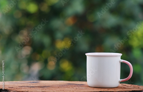 cup of coffee on wood counter background and space for text