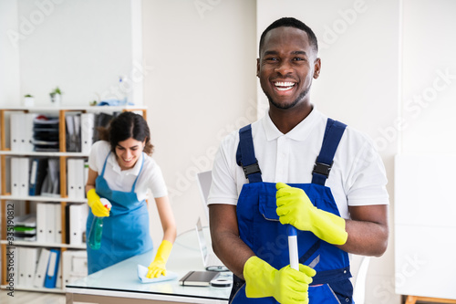 Happy Male Janitor In Office photo